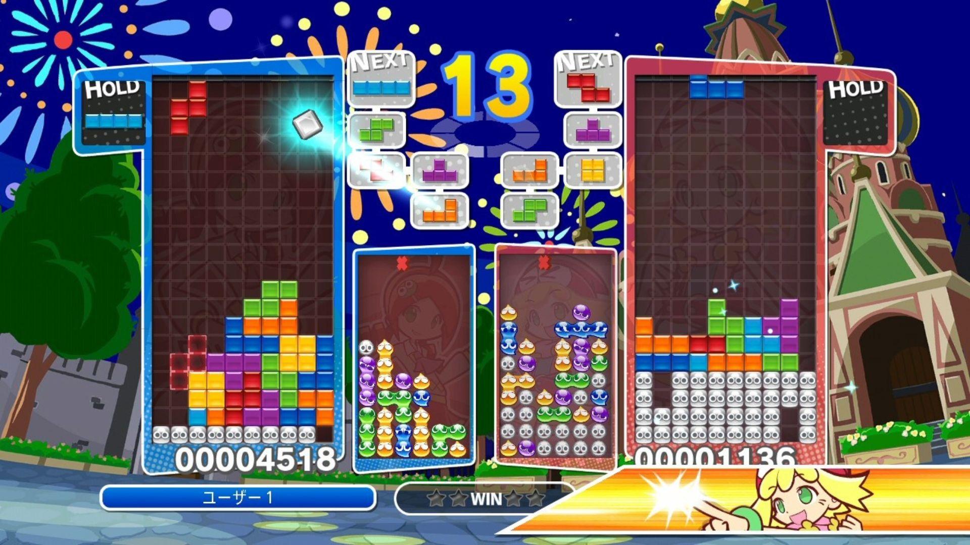 One of the many Tetris games, Puyo Puyo Tetris, showing two puzzle screens with Tetris blocks falling and smaller puzzle screens showing a game of Puyo Puyo. The screen is covered in colours and blocks falling, as well as numbers popping up.