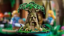 Lego The Legend of Zelda: The Lego Deku Tree in Ocarina of Time form, outlined in white and pasted on a blurred photo of Link and Zelda's minifigs