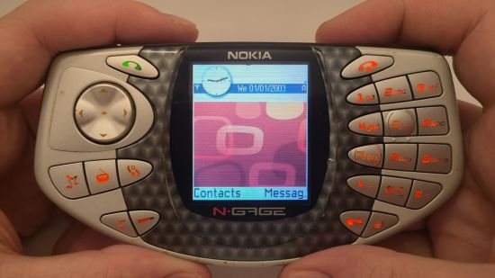 Custom image for Nokia N-Gage review with the reviewer holding the phone while its on the home screen