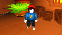 Anime Strike Simulator codes - an avatar in a blue pizza jumper and red beanie stood in front of some boxes and a plant
