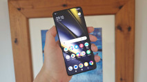 Image for Poco F6 review showing the phone in the reviewers hand with the home screen open